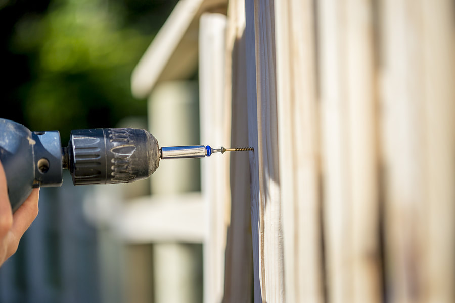 drilling the nail to the fence